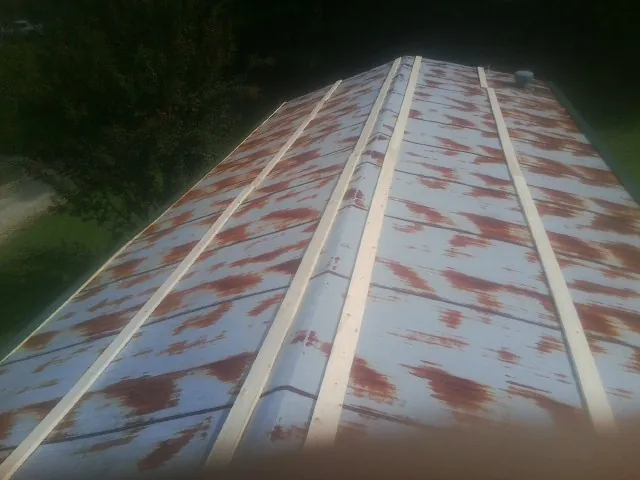Rusted metal roof panels with new wood purlins before replacement — Storm Damage Roof Repair in Atomic City by Roofing Brothers